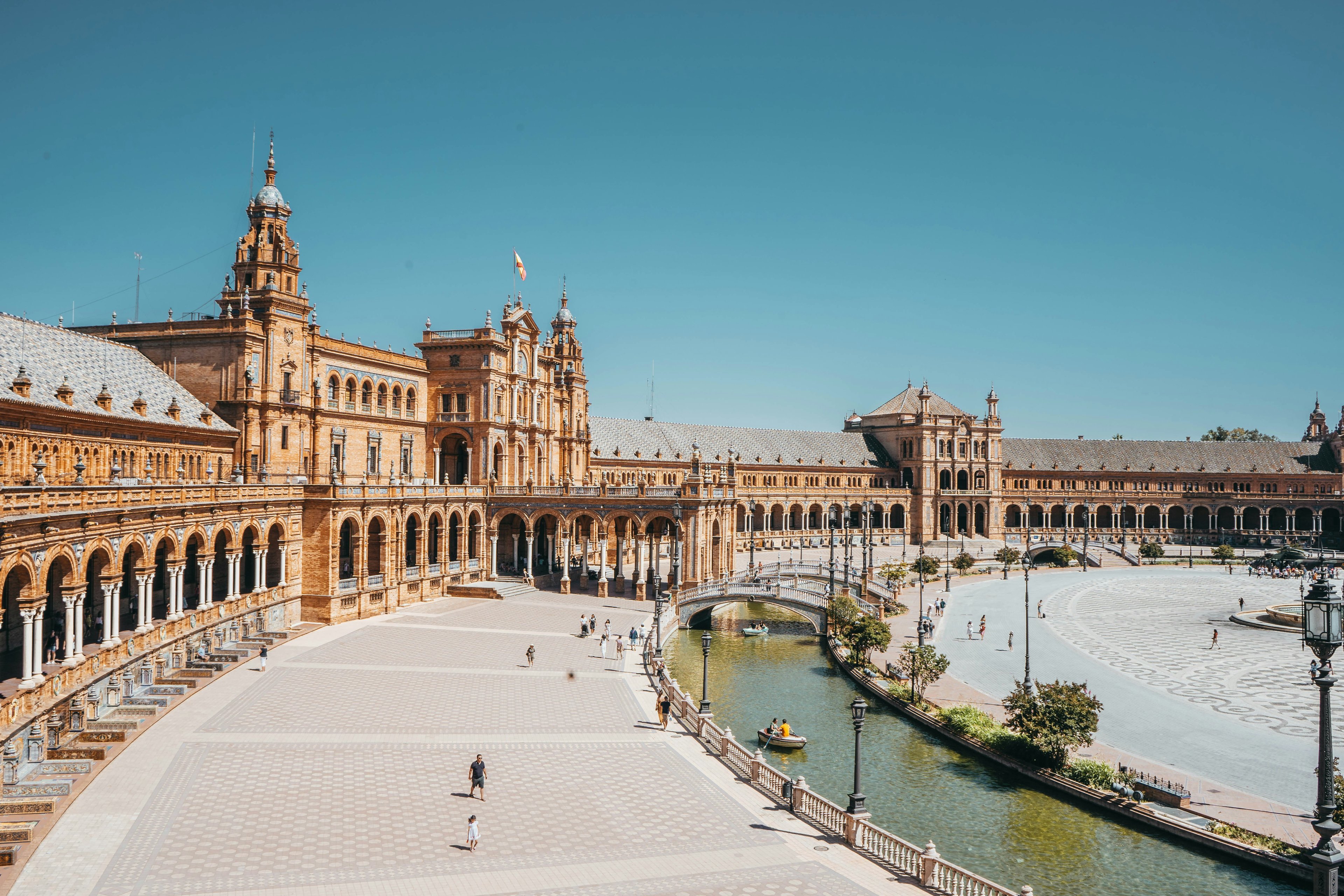 Plaza de España in Seville at golden hour with ornate brickwork and towers