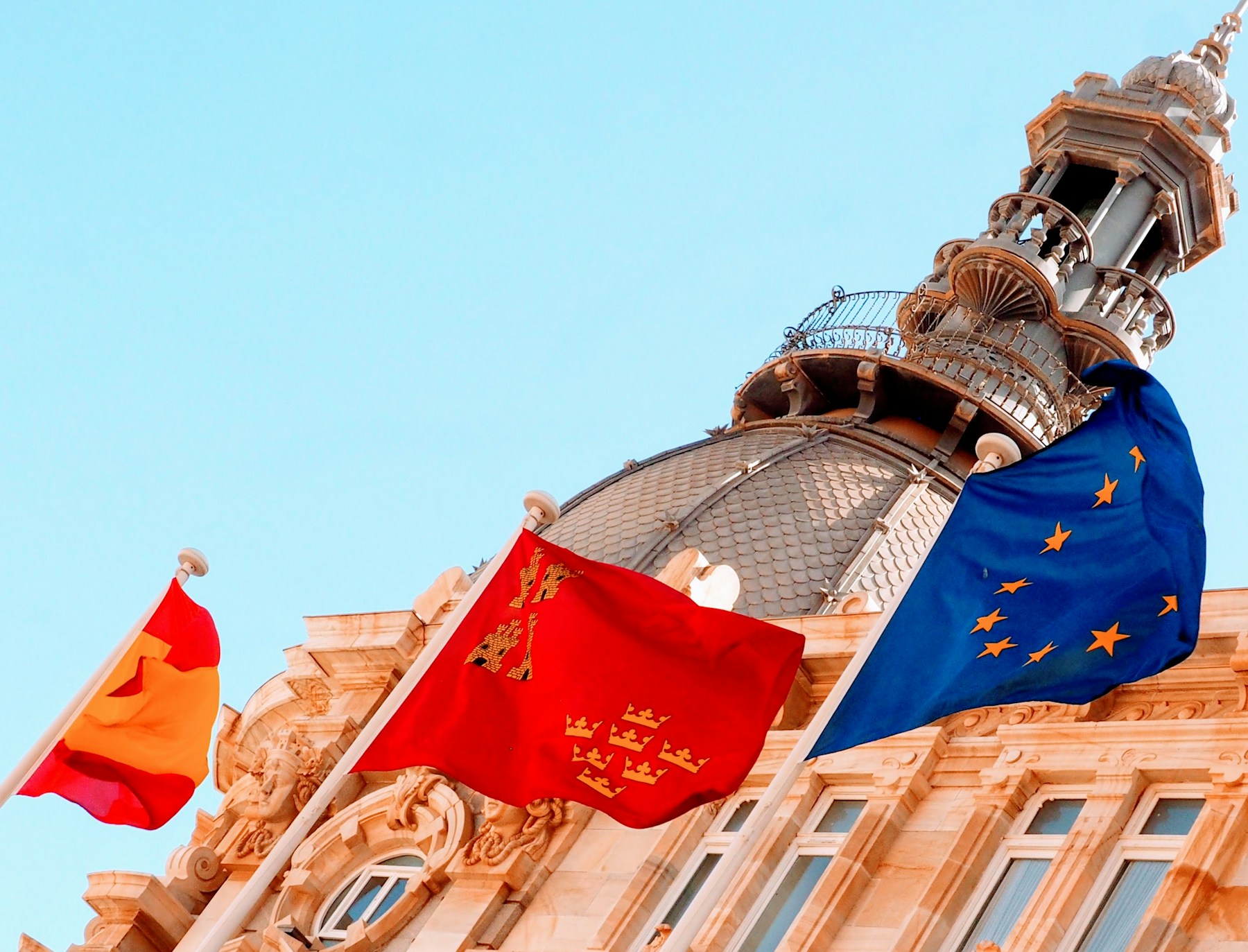 Dome of Cartagena's city hall, with the flags of Spain, Murcia and the European Union