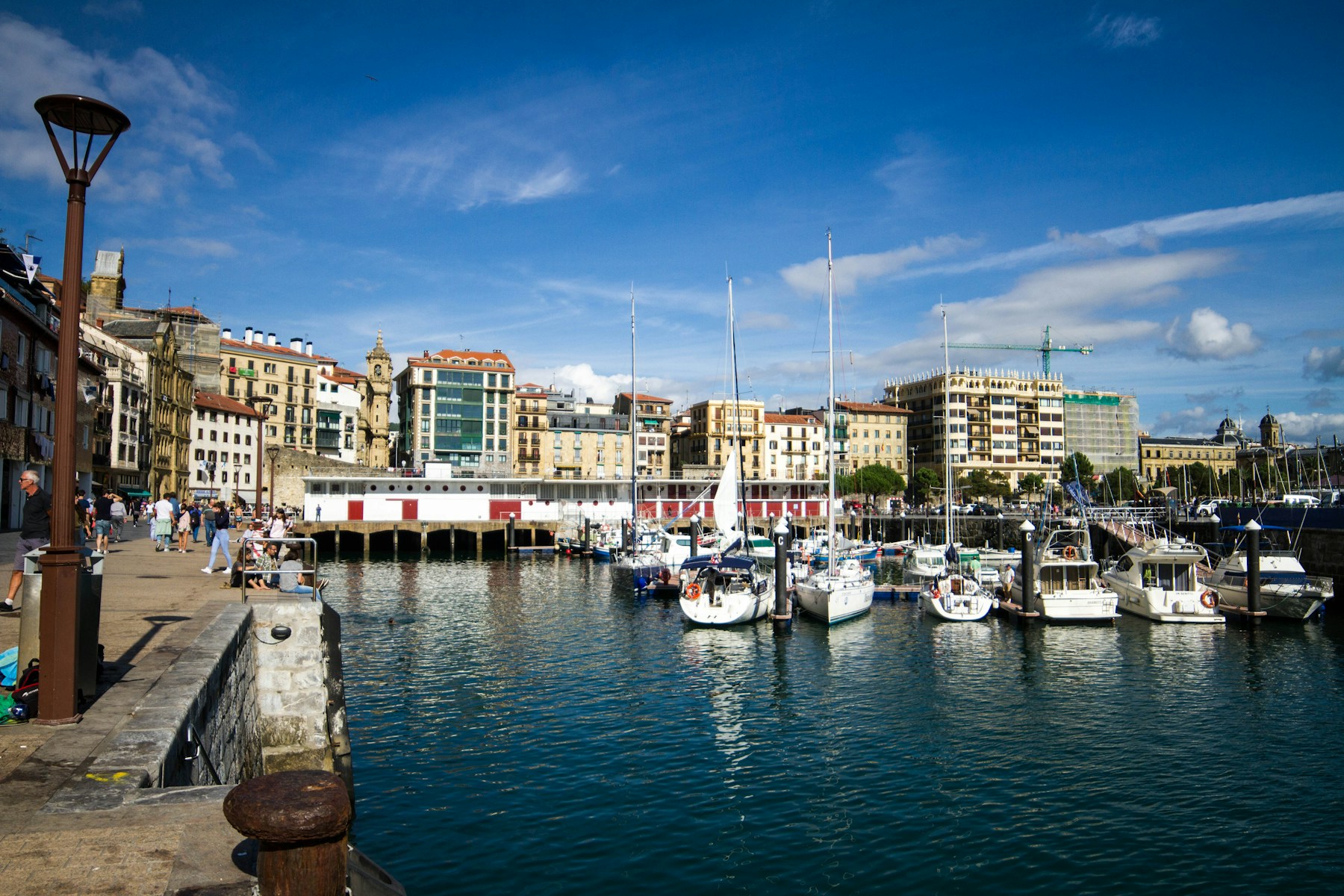Puerto de San Sebastián con barcos y casas junto al agua